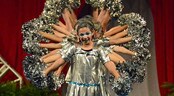 Pop Warner National Cheer & Dance Championships Teammates stand behind a cheerleader and shake their pom-poms, making her appear to have several arms
