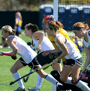 Field Hockey Showcase A field hockey player tries to control a ball while her opponent attempts to steal it
