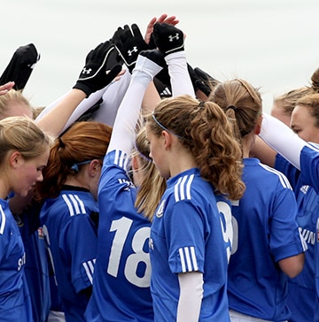 Disney Soccer Showcase Qualifier A soccer team of teenage girls huddle for a pre-game mass high-five