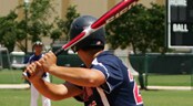 Disney Sun & Surf Baseball Bash baseball player swings a bat