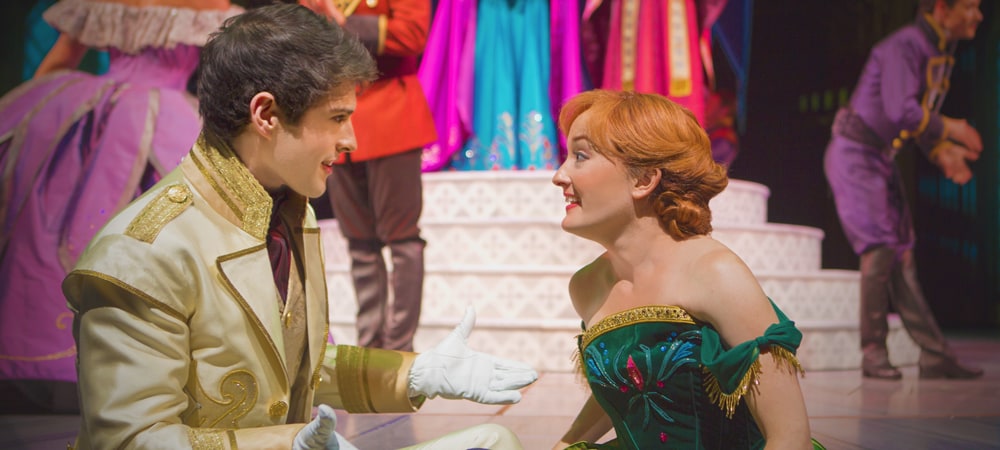 Princess Anna and Prince Hans kneeling and gazing at one another