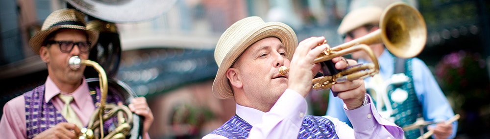Trumpet player and jazz band in a parade during the New Orleans Bayou Bash and Mardi Gras event Trumpet player and jazz band in a parade during the New Orleans Bayou Bash and Mardi Gras event