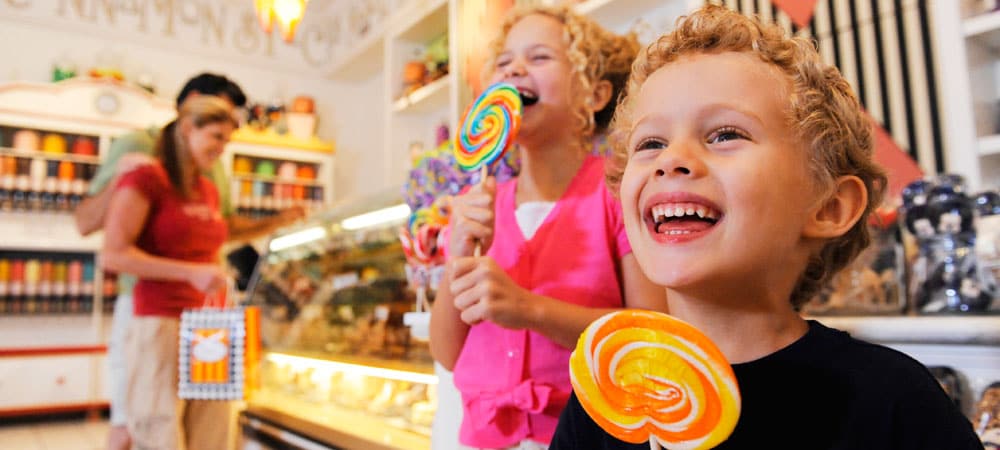 Delighted Kids with Lollipops at Marceline's Confectionery
