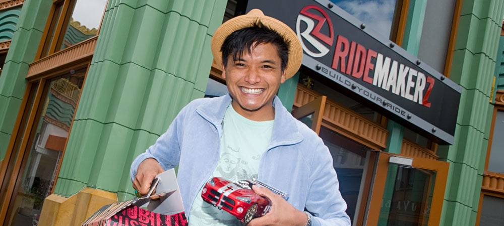 Man with Model Car in Front of RIDEMAKERZ