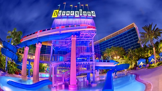 Disneyland Hotel Disney Vacation Club An Outdoor Pool And Waterslide Of Disneyland Hotel At Nighttime