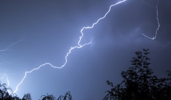 Weather Policy Lightning crackles in a cloudy sky