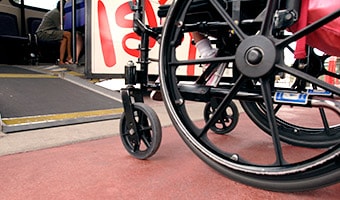 Wheelchairs A wheelchair in front of a small ramp leading onto a Disney Transport bus