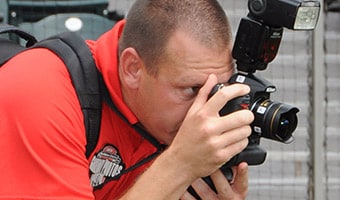Sports Photographer A Gameday Photos photographer prepares to snap a picture