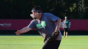 USSSA Slow Pitch World Series Session I A pitcher wearing a face guard follows through on an underhand pitch