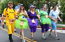 Runners dressed as characters from "Monsters, Inc." approach the finish line during Disneyland Half Marathon Weekend.