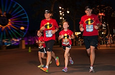 Runners dressed as "The Incredibles" run through Disney California Adventure Park during Disneyland Half Marathon Weekend.