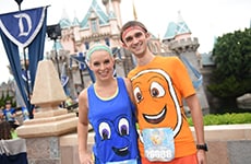 Runners dressed as characters from "Finding Nemo" and "Finding Dory" pose in front of Sleeping Beauty Castle at Disneyland Park during Disneyland Half Marathon Weekend.
