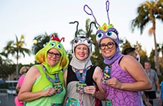 Runners dressed as characters from "A Bug's Life" pose with their finisher medals during Disneyland Half Marathon Weekend at Disneyland Resort