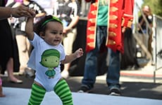 Baby runner dressed as Disgust from "Inside Out" participates in the Diaper Dash at the runDisney Kids Races during Disneyland Half Marathon Weekend at Disneyland Resort.