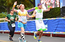 Runners dressed as "Toy Story" characters run toward the finish line of Disneyland Half Marathon.
