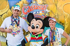 Runners celebrate with Mickey Mouse after the Castaway Cay 5K for the Castaway Cay Challenge during Walt Disney World Marathon Weekend.