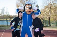 Runners pose with Goofy during the Walt Disney World Marathon.