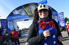 Runner dressed as Donald Duck finishes the Walt Disney World Half Marathon.