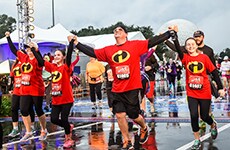 Family of runners cross the finish line during the Walt Disney World 10K.