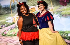 Runner poses with Snow White during Disney Princess Half Marathon Weekend at Walt Disney World Resort.