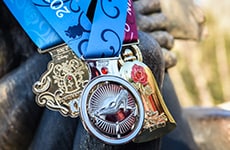 Race medals for runners participating in the Disney Fairy Tale Challenge during Disney Princess Half Marathon Weekend at Walt Disney World Resort.