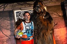 Runner poses with Chewbacca before the Star Wars Rival Run 5K.