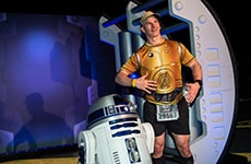 Runner poses with R2-D2 during Star Wars Rival Run Weekend.