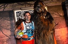 Runner poses with Chewbacca before the Star Wars Rival Run 5K.