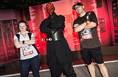 Runners pose with Darth Maul before the Star Wars 10K during Star Wars Half Marathon – The Dark Side race weekend.