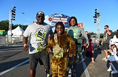 Runners cross the finish line of the Star Wars 5K during Star Wars Half Marathon – The Dark Side race weekend.