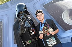 Runner celebrates after Star Wars Half Marathon – The Dark Side with Darth Vader.