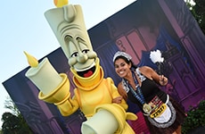 Runner celebrating with Lumiere after the Disney Wine & Dine 10K