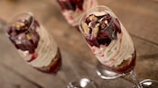 Champagne flutes stuffed with ice cream, nuts, berries and whipped cream