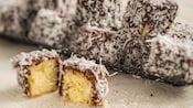 Small cakes covered in chocolate and shredded coconut