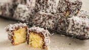 Small cakes covered in chocolate and shredded coconut