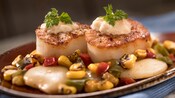 Scallops paired with herbs, corn, bell peppers and sauce