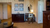 Living room has coffee table, entertainment center, dresser and desk with chair