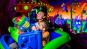 Two brothers enjoy Buzz Lightyear's Space Ranger Spin