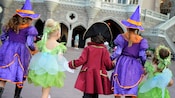Five kids in different costumes walking into Mickey’s Not-So-Scary Halloween Party