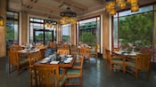 Oak furnishings, wood beams and large windows with forest views in the Artist Point dining room