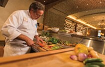 Culinary Offerings at Summerhouse A chef preps food in a restaurant kitchen