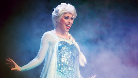 Elsa performs on a foggy stage during For the First Time in Forever: A Frozen Sing-Along Celebration