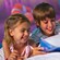 A boy and girl enjoy playing a game together at Disney’s Art of Animation Resort