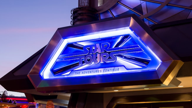 Disneyland for adults: As night falls, the illuminated entrance sign for Star Tours The Adventures Continue welcomes Guests