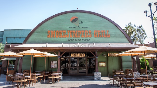 Exterior of Smokejumpers Grill with tables, chairs and umbrellas at Disneys California Adventure Park