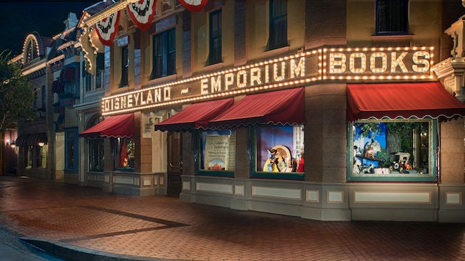 Patriotic flag banners cascade from the storefront as lights outside the Emporium illuminate the night
