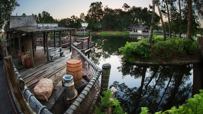 A wooden dock where Guests embark on rafts across Rivers of America to Tom Sawyer Island