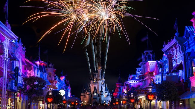 Fireworks light up the night sky above Cinderella Castle at the tip of Main Street, USA which is decorated with illuminated Mickey Mouse lanterns