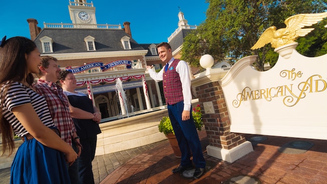 A tour guide talks to his walking-tour Guests outside The American Adventure pavilion of World Showcase at Epcot in Walt Disney World Resort