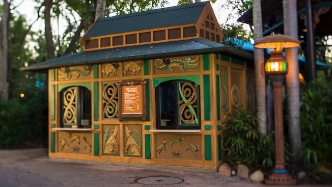 A kiosk with a menu and a sign that reads The Smiling Crocodile